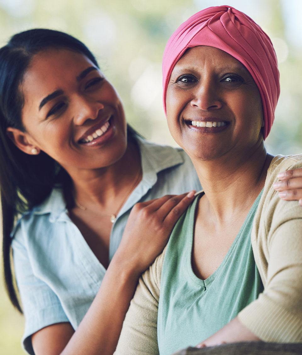Photo of a mother, who is a patient, and daughter, both smiling