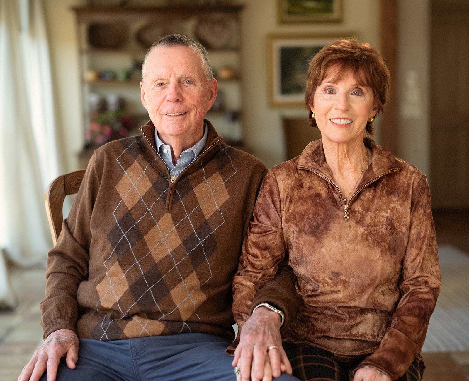 Photo of Sandy and John Black sitting and smiling