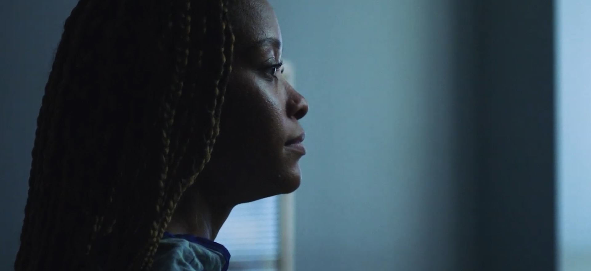 Side profile of a woman staring forlornly off-camera