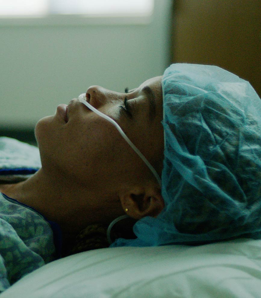 Forlorn medical patient lying in a hospital bed